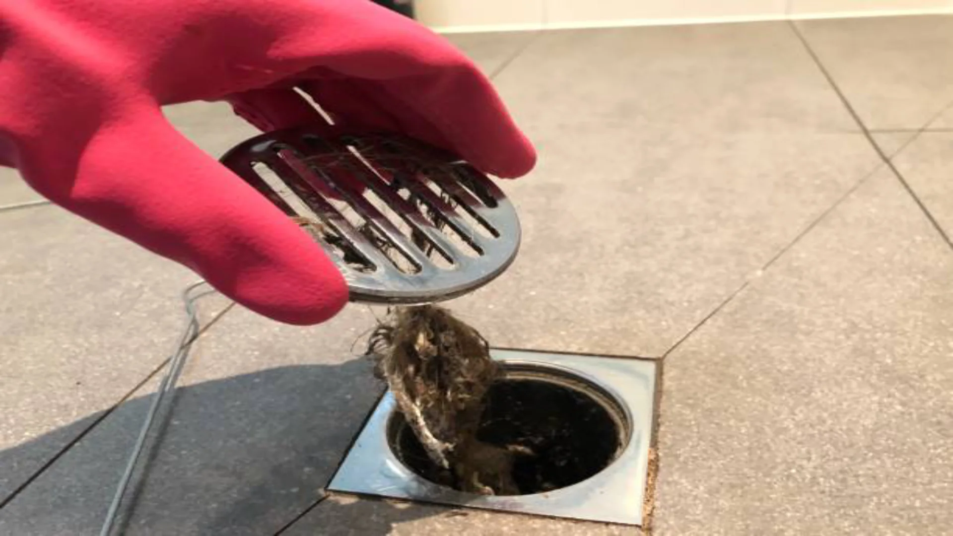 A clean shower drain with water flowing smoothly, symbolizing regular maintenance and cleanliness.